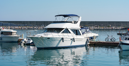 A boat sailing on clear blue water, representing boat and watercraft insurance.