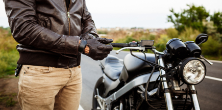 A motorcyclist riding on an open road, illustrating the need for motorcycle insurance.
