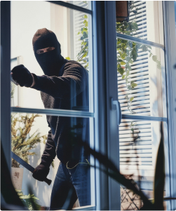 A broken window, representing theft and vandalism to personal belongings.